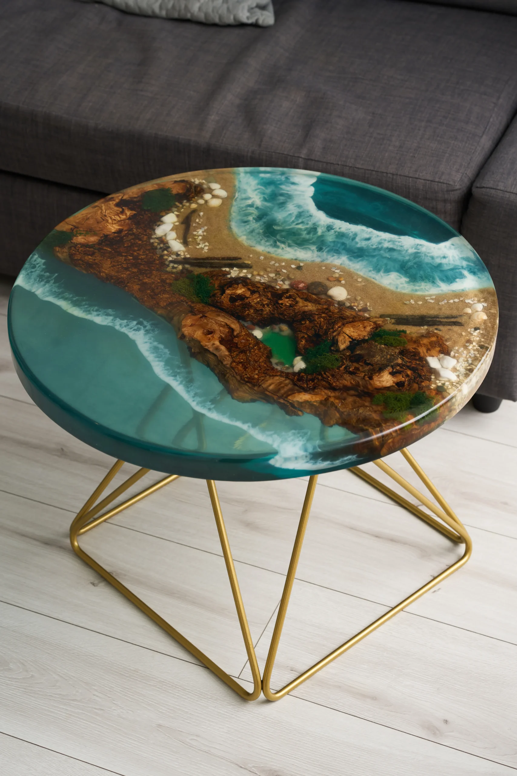 Stolik kawowy z epoksydową powierzchnią, ukazujący plażowy krajobraz w odcieniach niebieskiego.